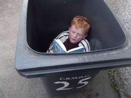 Child reading in a bin